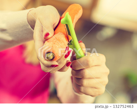 Woman peeling carrot vegetable Woman peeling carrot vegetable 132752463