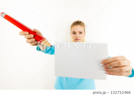 Woman with big pencil writing on paper Woman with big pencil writing on paper 132752466