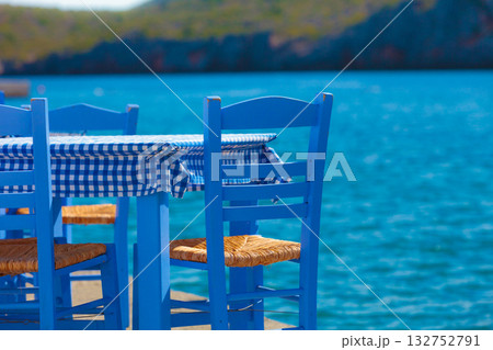 Open cafe outdoor restaurant in Greece on sea shore 132752791