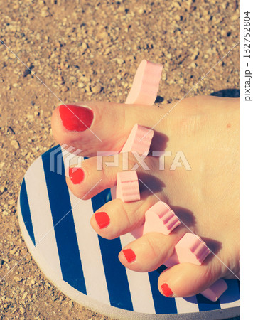 Woman drying her nail polish after pedicure Woman drying her nail polish after pedicure 132752804