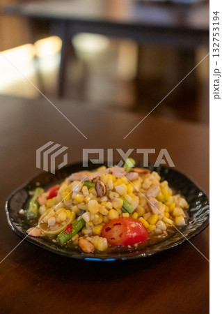 Spicy corn with salted egg salad, or Som Tum with corn, served on plate. 132753194
