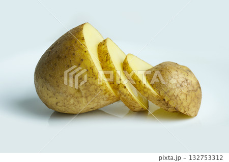 Sliced yellow potato pieces on a clean surface. High quality photo Sliced yellow potato pieces on a clean surface. High quality photo 132753312