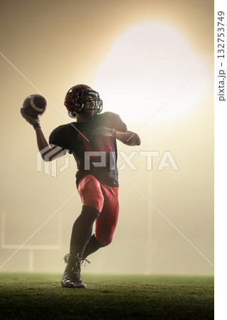 Creative collage with blur motion effect of quarterback throwing football under stadium lights. 132753749