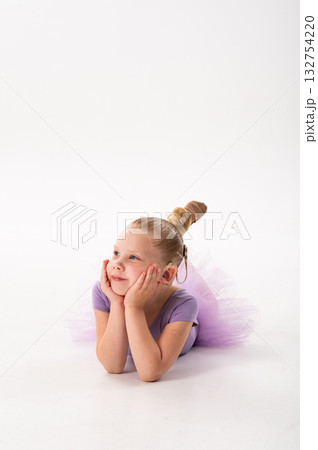 Girl with cochlear implant lying and smiling to the side. Hearing recovery, childhood confidence, and inclusion in modern education and art. 132754220