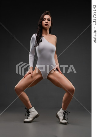 Sensual woman poses in elegant lingerie with striking footwear 132755142