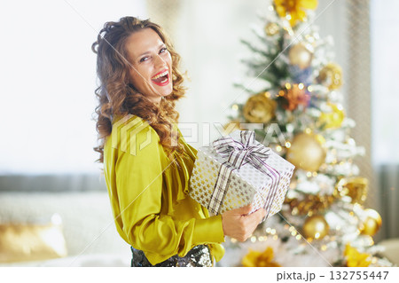 Woman in Chartreuse Blouse with Christmas Gift 132755447