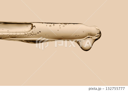 Serum in a pipette close-up on a beige background. 132755777