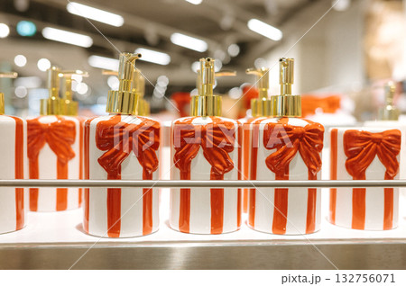 Festive soap dispensers with red ribbons on display 132756071