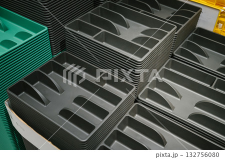 Cutlery Storage Container. Stacked black and green plastic food trays in storage position Cutlery Storage Container. Stacked black and green plastic food trays in storage position 132756080