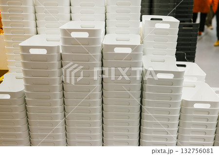 Stacked white plastic storage bins in warehouse setting 132756081
