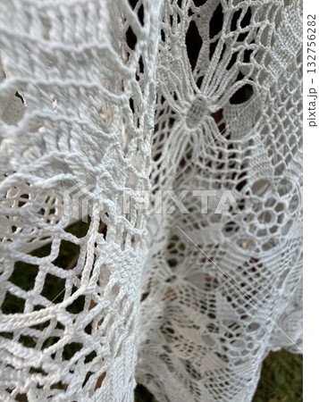 White lace fabric showcasing intricate patterns and textures for elegant textile background 132756282