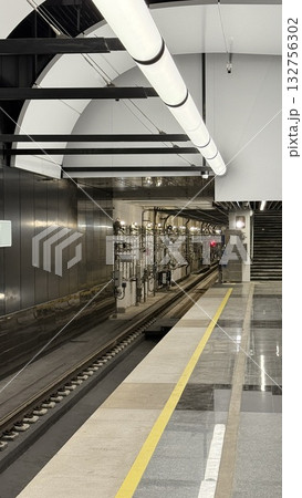 Subway platform with empty tracks and modern architectural design, suitable for travel theme background Subway platform with empty tracks and modern architectural design, suitable for travel theme background 132756302