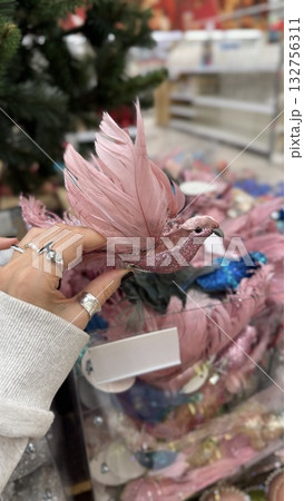 Christmas ornament featuring a pink bird with glitter used as festive decoration 132756311