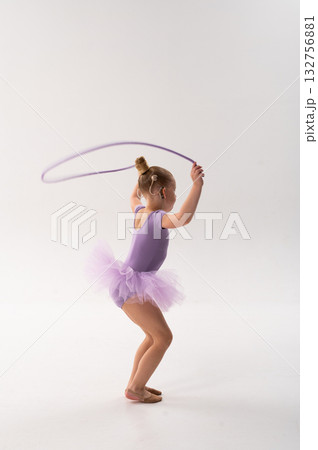 Little ballerina with cochlear implant holding jump rope in studio. Inclusive childhood, hearing technology, and confidence through rhythm, grace, and balance. Little ballerina with cochlear implant holding jump rope in studio. Inclusive childhood, hearing technology, and confidence through rhythm, grace, and balance. 132756881