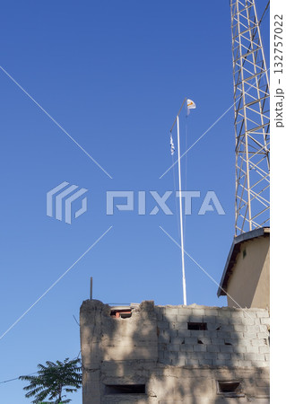 Greek and Cypriot flags on poles above a divided building in Cyprus Green Zone. Greek and Cypriot flags on poles above a divided building in Cyprus Green Zone. 132757022
