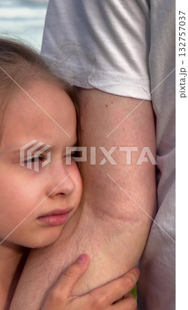 Girl hugging parent, Childhood innocence, Gentle outdoor hug, Secure in arms, Loving moment, Supportive parent, Protection and trust, Intimate family scene, Heartwarming childhood, Childhood affection 132757037