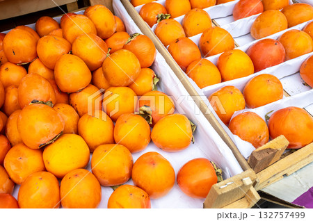Organic ripe persimmon ready for sale at the farmers market 132757499