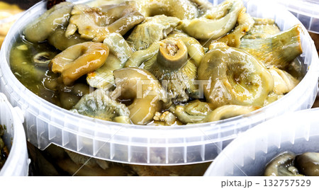 Pickled mushrooms sold on the market. Marinated mushrooms, appetizer of pickled mushrooms Pickled mushrooms sold on the market. Marinated mushrooms, appetizer of pickled mushrooms 132757529