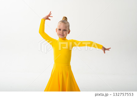 Young dancer with cochlear implant performing dance pose. Strength, adaptability, and inclusion merge in a story of overcoming hearing barriers through art, discipline, and body control. 132757553