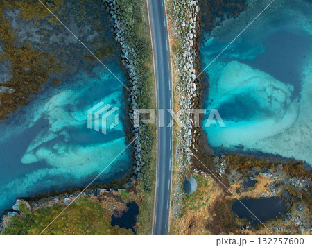 Aerial view of bridge, sea with waves and stones at sunset 132757600