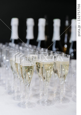Glasses of sparkling champagne on white table at elegant celebration or corporate event Glasses of sparkling champagne on white table at elegant celebration or corporate event 132757708