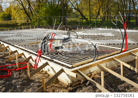 Underfloor heating system installation in concrete foundation construction site Underfloor heating system installation in concrete foundation construction site 132758161