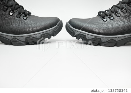 Pair of black winter leather warm boots with laces on white Pair of black winter leather warm boots with laces on white 132758341