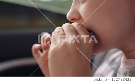 little girl child eating burger in car, happy person, Satisfying road hunger, fast food happiness, stripe-shirt girl, car seat munching, travel experience, burger love, little explorer, meal with a 132758422