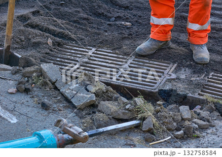 Removing a storm drain grate using a jackhammer Removing a storm drain grate using a jackhammer 132758584