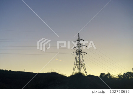 Power Line Tower at Sunset. Energy and Industrial Silhouette Power Line Tower at Sunset. Energy and Industrial Silhouette 132758653