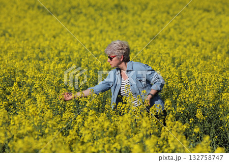 Female agronomist examining blossoming rapeseed field Female agronomist examining blossoming rapeseed field 132758747