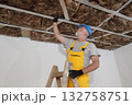 Senior adult worker apply insulation for gypsum ceiling 132758751