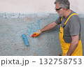 Worker preparing wall for tile gluing 132758753