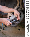 Car mechanic working on disc brakes 132758819