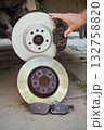 Car mechanic working on disc brakes 132758820