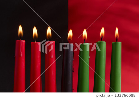 African American Kwanzaa holiday concept with traditional lit candles. Seven candles red, black and green African American Kwanzaa holiday concept with traditional lit candles. Seven candles red, black and green 132760089