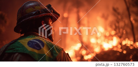 Brazilian Firefighter Faces Jungle Blaze with National Flag in Background 132760573