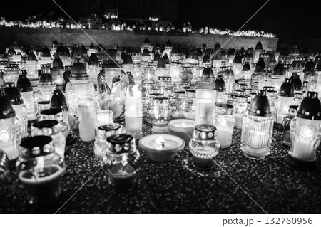 All Saints Day candles and lanterns at cemetery memorial, night background in Poland All Saints Day candles and lanterns at cemetery memorial, night background in Poland 132760956