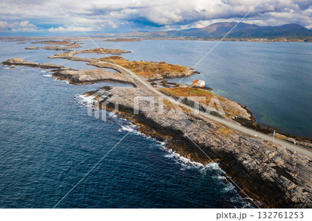 Extensive Atlantic ocean road gracefully weaves across small islands and over narrow channels. Norway challenging coastal geography under cloudy sky Extensive Atlantic ocean road gracefully weaves across small islands and over narrow channels. Norway challenging coastal geography under cloudy sky 132761253