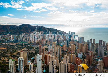 Breathtaking aerial panorama of Benidorm showing its famous high rise buildings, golden beaches, and calm blue waters of the Mediterranean. Sunny coastal resort city in southern Spain with skyline and 132761256