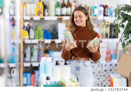 Young woman choosing dishwashing liquid in department store Young woman choosing dishwashing liquid in department store 132763744