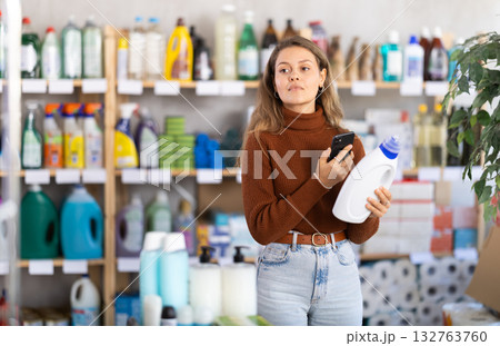 Young woman scanning qr code for detergent 132763760