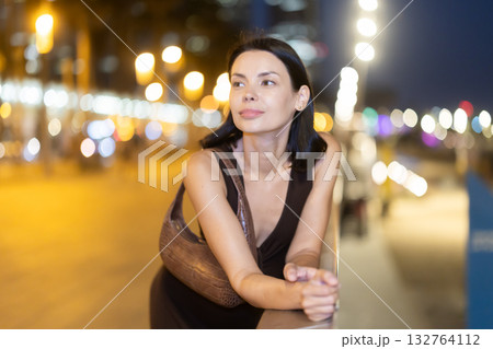 Young woman leaning on parapet at Barceloneta beach in summer evening Young woman leaning on parapet at Barceloneta beach in summer evening 132764112