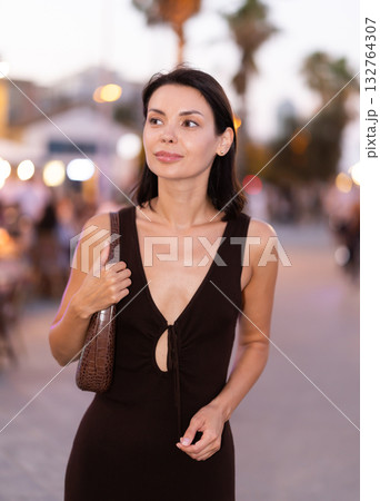 Young woman walking on a lively promenade of Barceloneta 132764307
