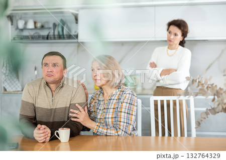 Family quarrel, old woman calming man 132764329