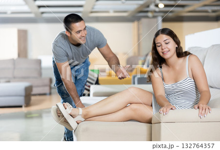 Man and woman are choosing of sofa in furniture store Man and woman are choosing of sofa in furniture store 132764357