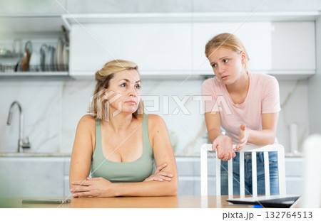Teenage daughter asking for forgiveness from upset mother Teenage daughter asking for forgiveness from upset mother 132764513