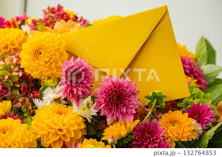 Yellow envelope gift present idea Flower delivery Selective focus Bush of autumnal orange red chrysanthemums and violet dahlia hydrangea. Fall garden beautiful flowers bouquet background. Blooming Yellow envelope gift present idea Flower delivery Selective focus Bush of autumnal orange red chrysanthemums and violet dahlia hydrangea. Fall garden beautiful flowers bouquet background. Blooming 132764853