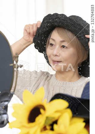 夏の外出で紫外線対策に帽子.サングラスを選ぶシニア女性 132764883