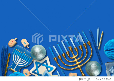 Hanukkah, menorah with candles, dreidels, and blue decorations Hanukkah, menorah with candles, dreidels, and blue decorations 132765302